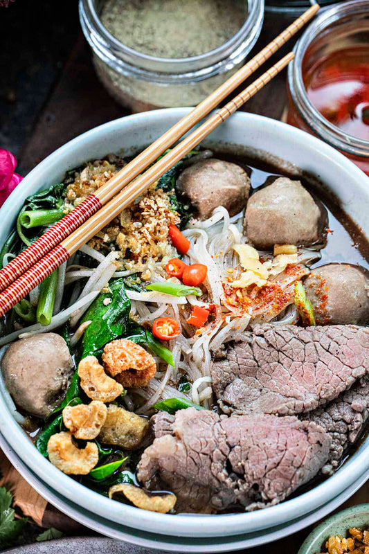 A bowl of Authentic Thai Boat Noodle Soup with Beef